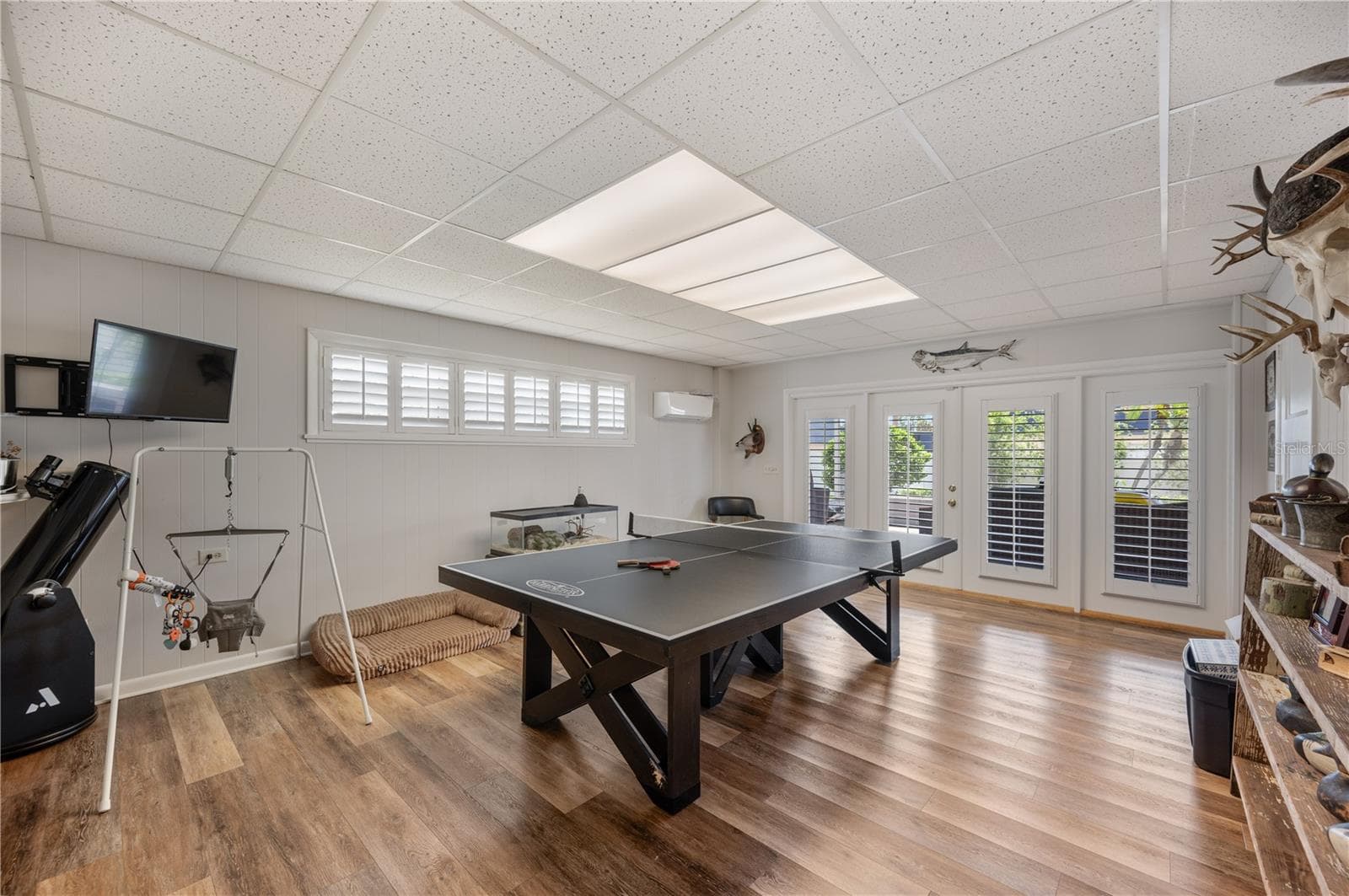 The game room is huge, with its very own newer Mini split AC. This room also has french doors that lead to a very large screened covered rear patio. - 1211 HUNT AVE, LAKELAND