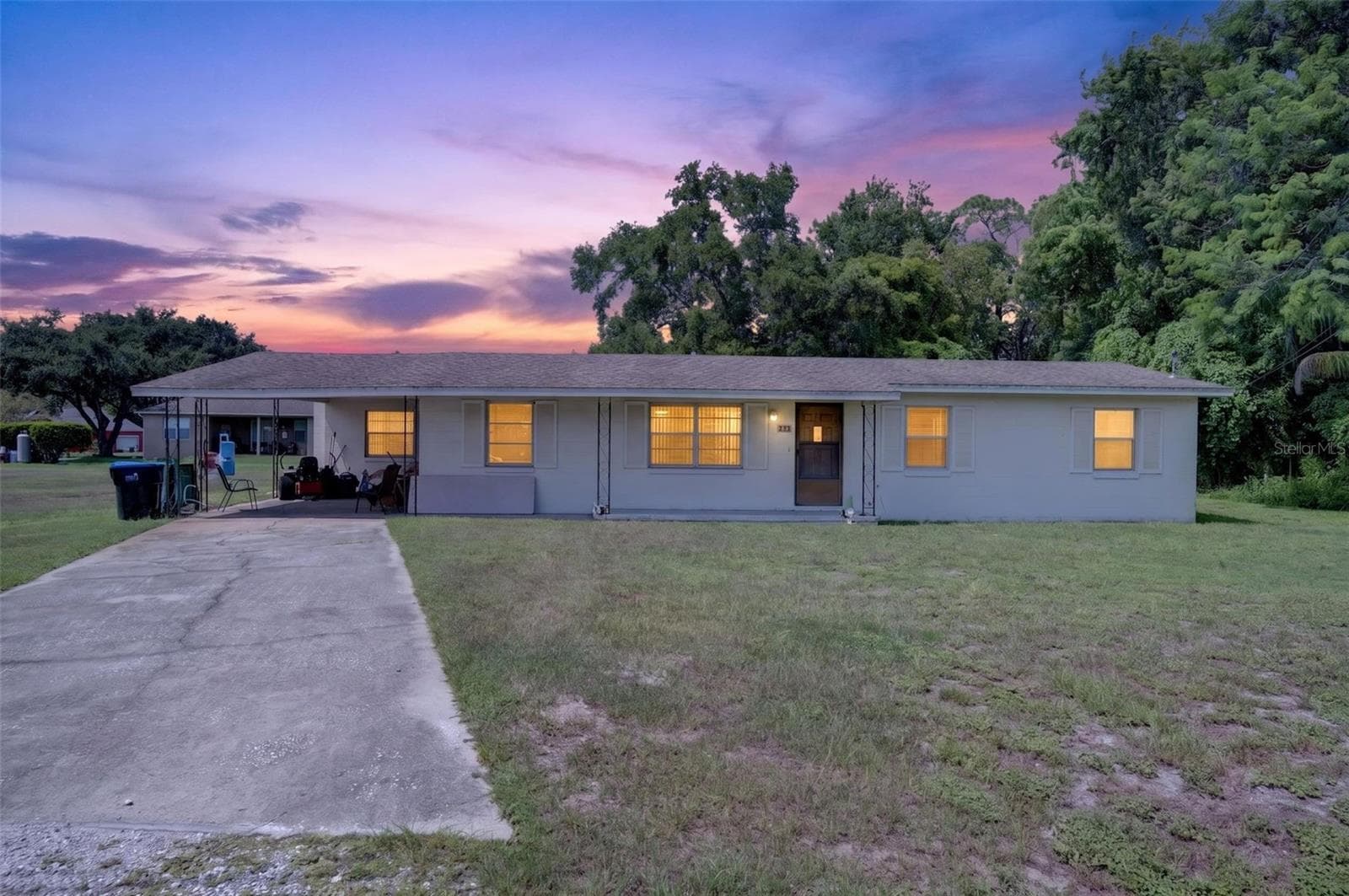 Twilight elevation of the existing 3BR/1BA home on the 1.03-acre site. - 212 15TH AVE, OCOEE