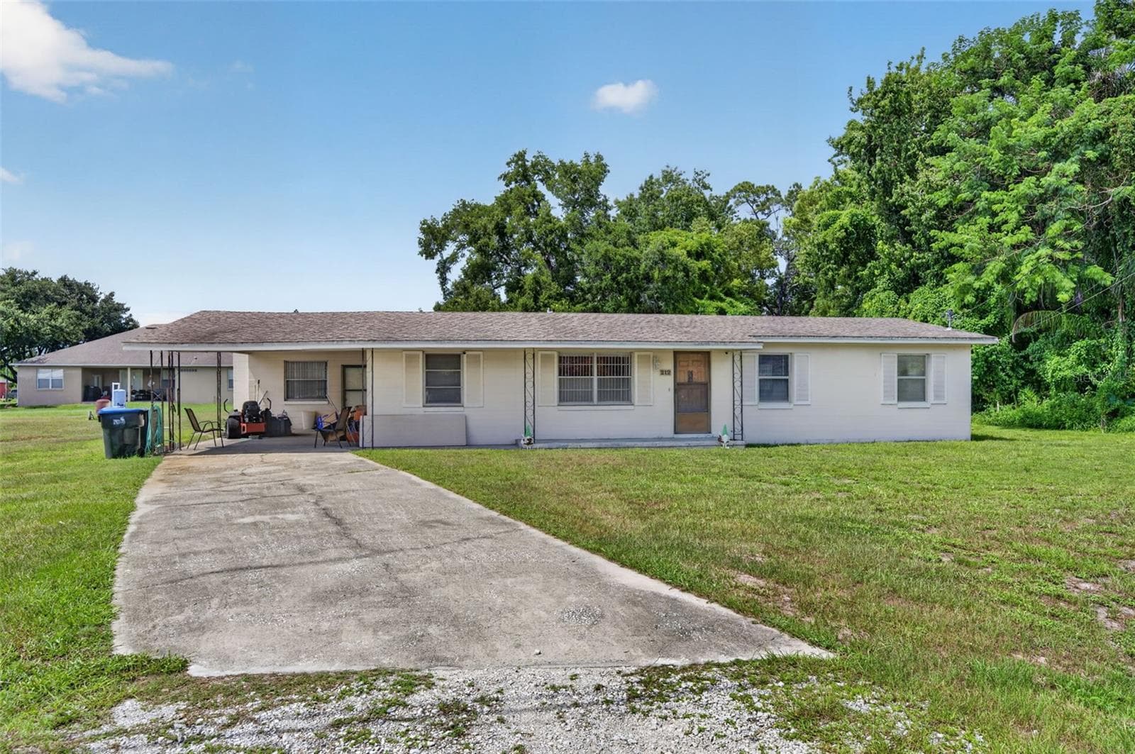 Concrete driveway leading to the carport/entry. - 212 15TH AVE, OCOEE