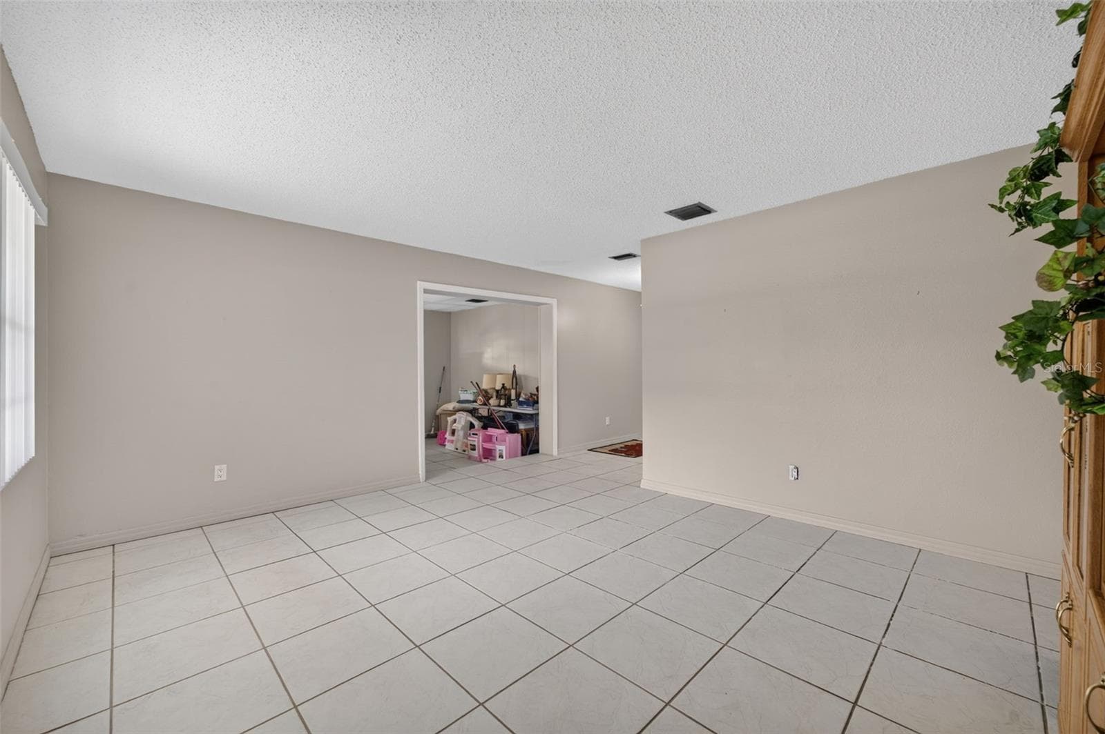 Living room, tile flooring throughout. - 212 15TH AVE, OCOEE