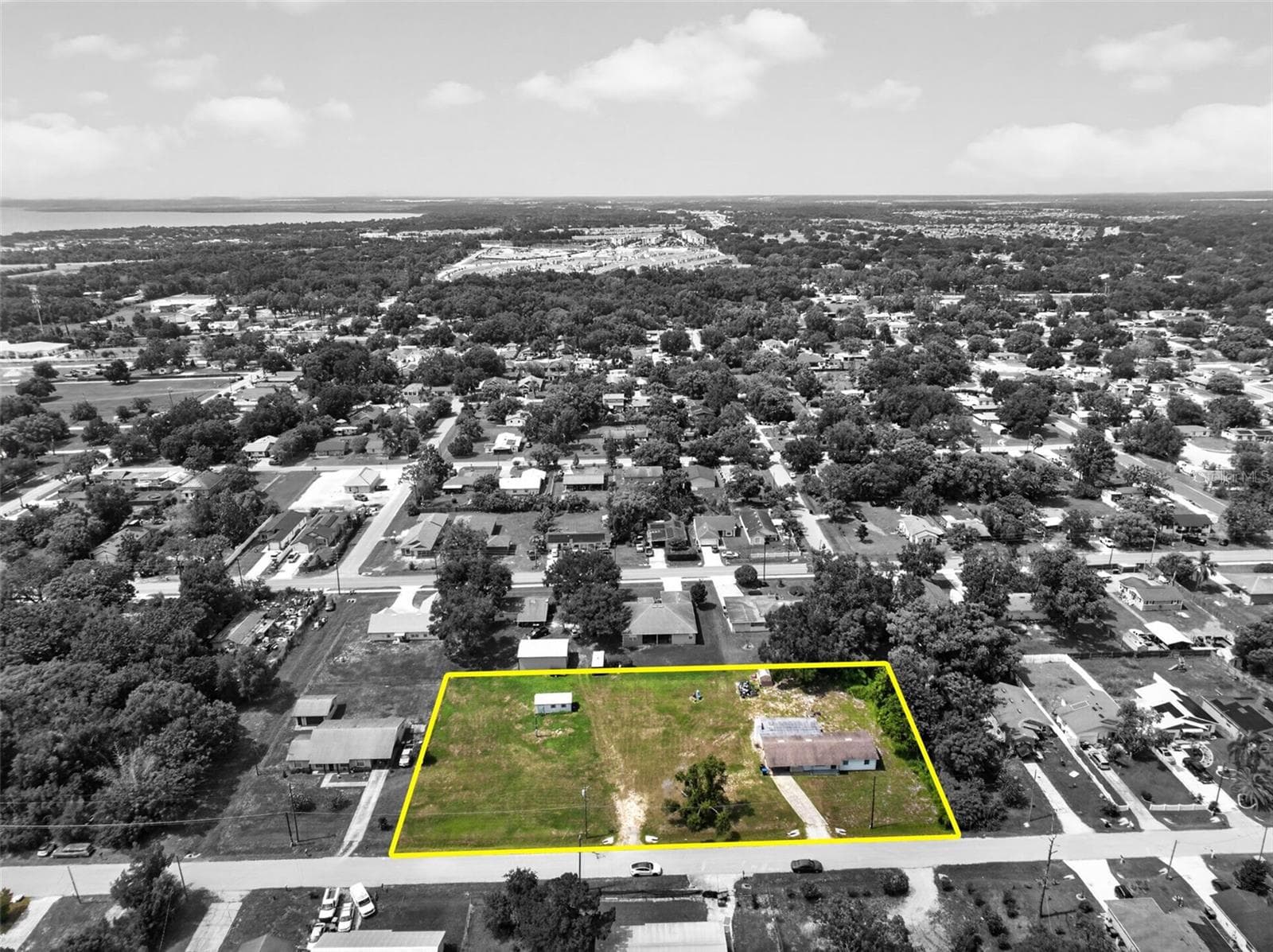 Aerial spotlight highlighting the subject parcel against the surrounding block. - 212 15TH AVE, OCOEE