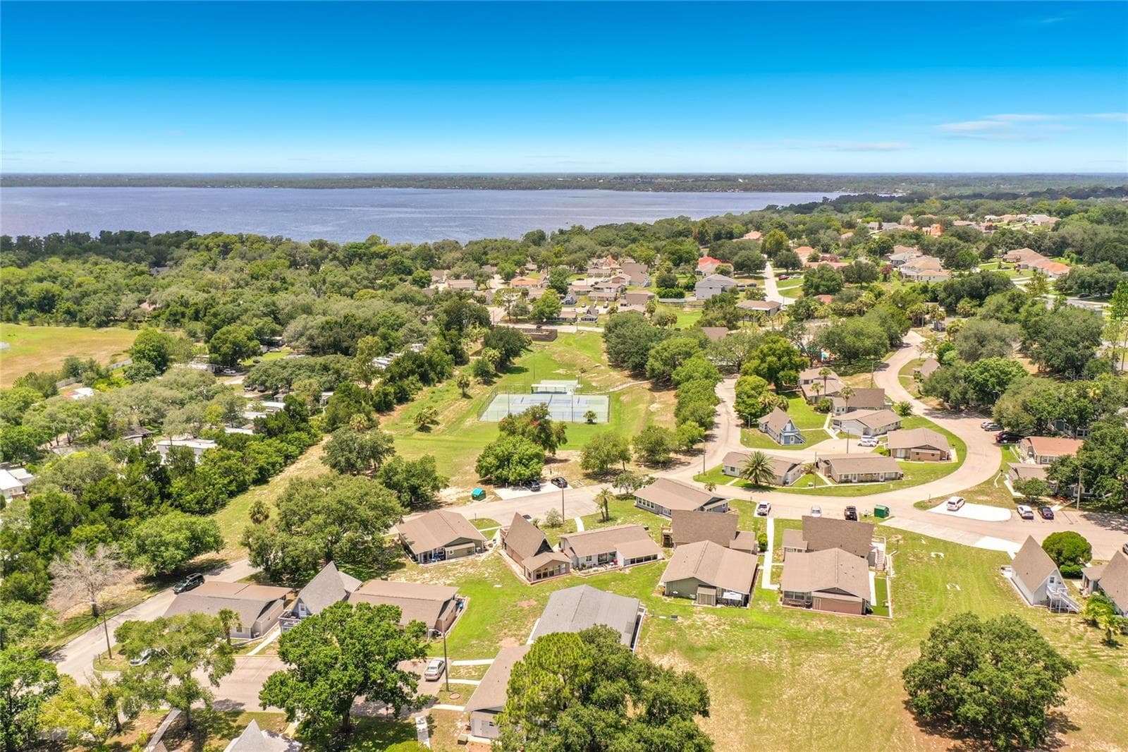 Tennis courts and Lake Lousia in the background. - 10301 US HIGHWAY 27 #22, CLERMONT