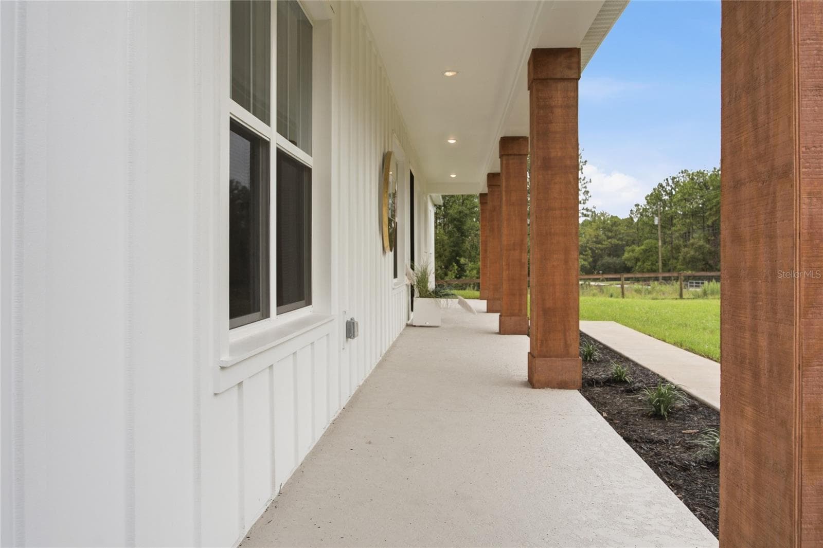 long porch for enjoying the views - 8730 NW 17TH CIR, OCALA