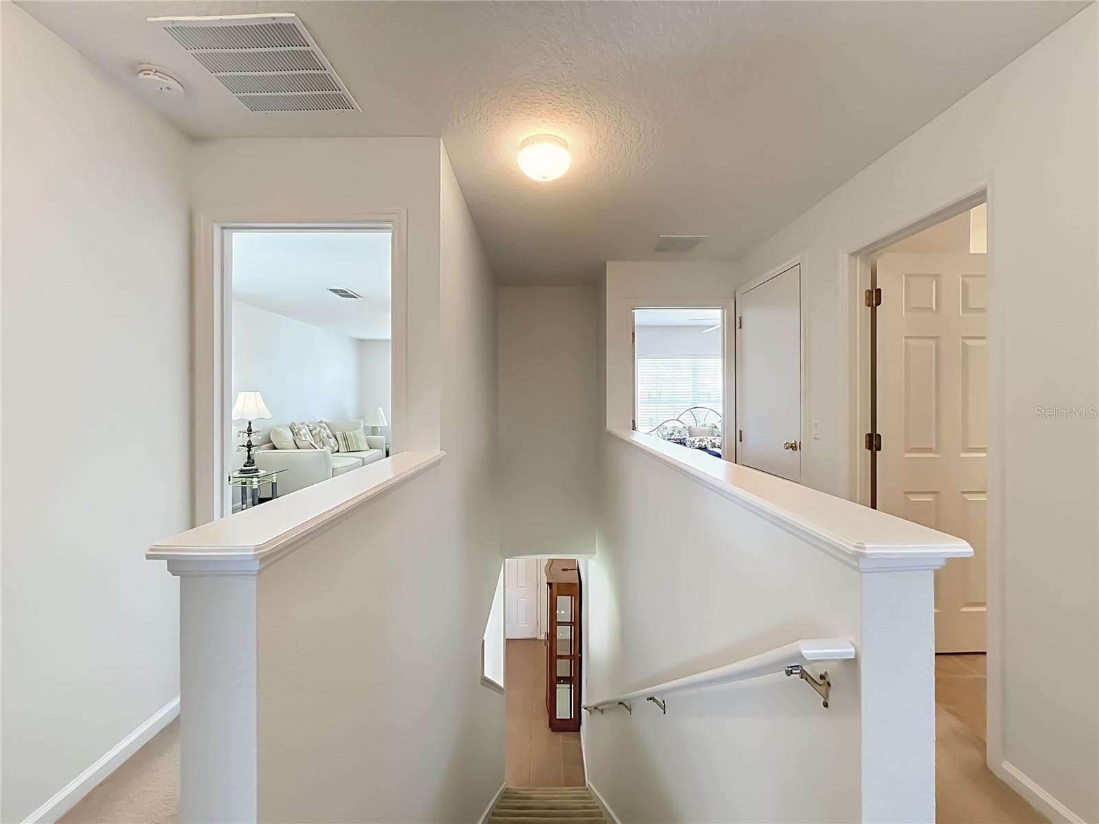Second floor landing with 2 rooms on the left and right view with full bath. - 16543 CEDAR CREST DR, ORLANDO