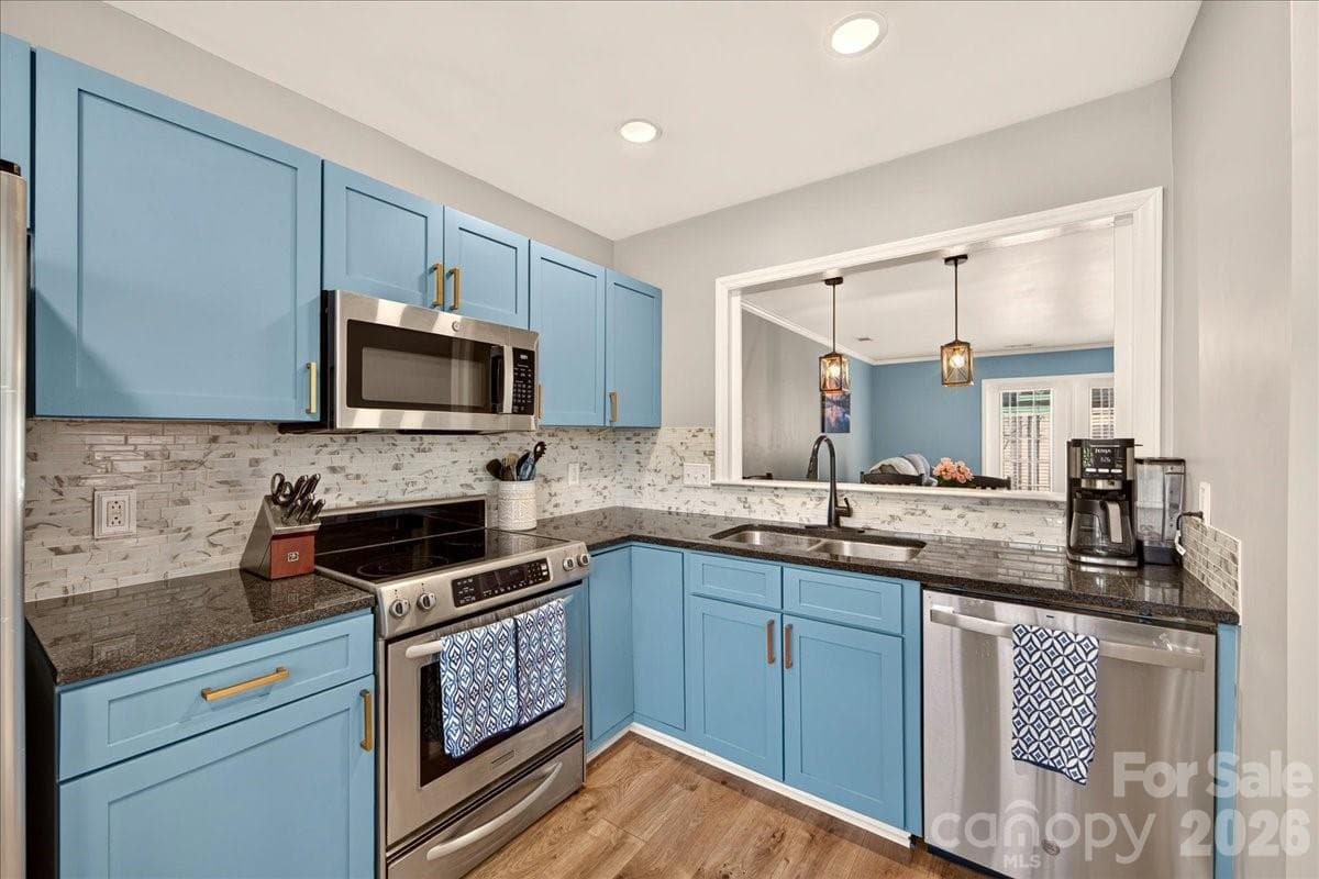 The kitchen opens to the main living area - 8220 Legare Court, Charlotte