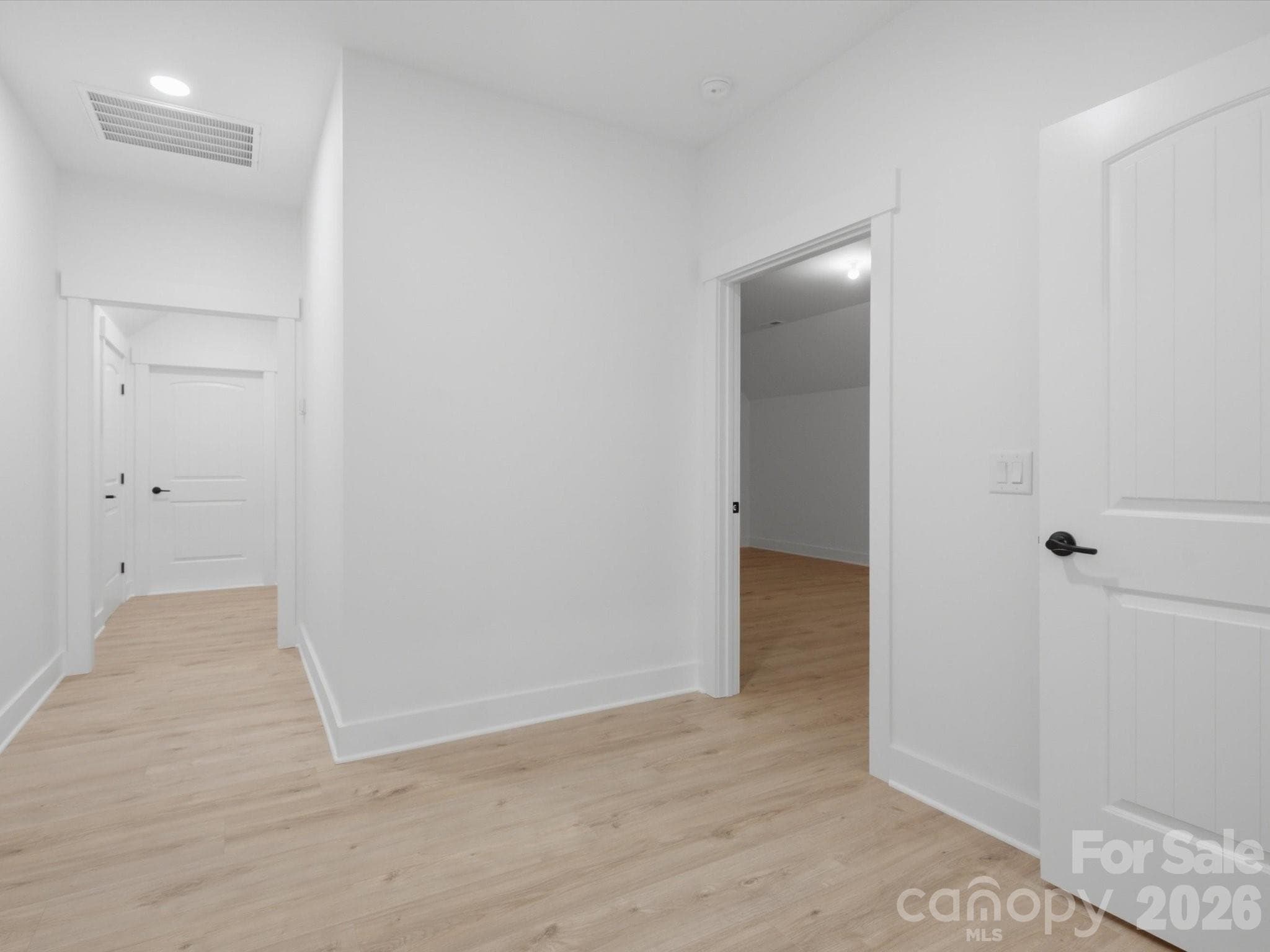 upstairs hallway with door to unfinished space - 8018 Fairmont Drive, Waxhaw
