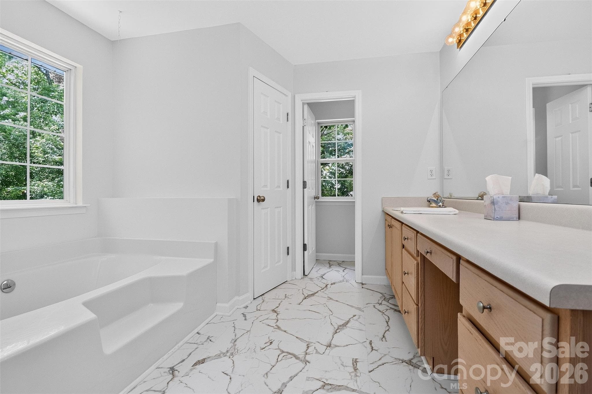 Light filled bathroom with new flooring! - 7912 Ritter Drive, Charlotte