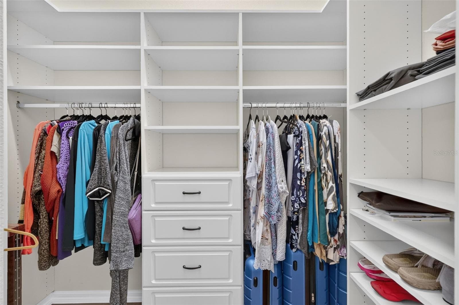 One of two walk-in closets in primary bedroom - 8716 BRIDGEPORT BAY CIR, MOUNT DORA
