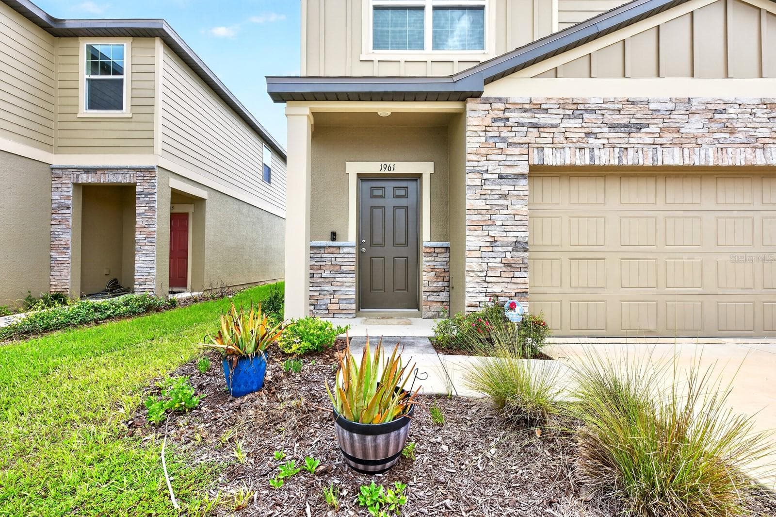 From the moment you arrive, the home's attractive curb appeal stands out with stone accents surrounding the garage and front exterior, creating a warm and welcoming first impression. - 1961 HEMINGWAY CIR, GROVELAND