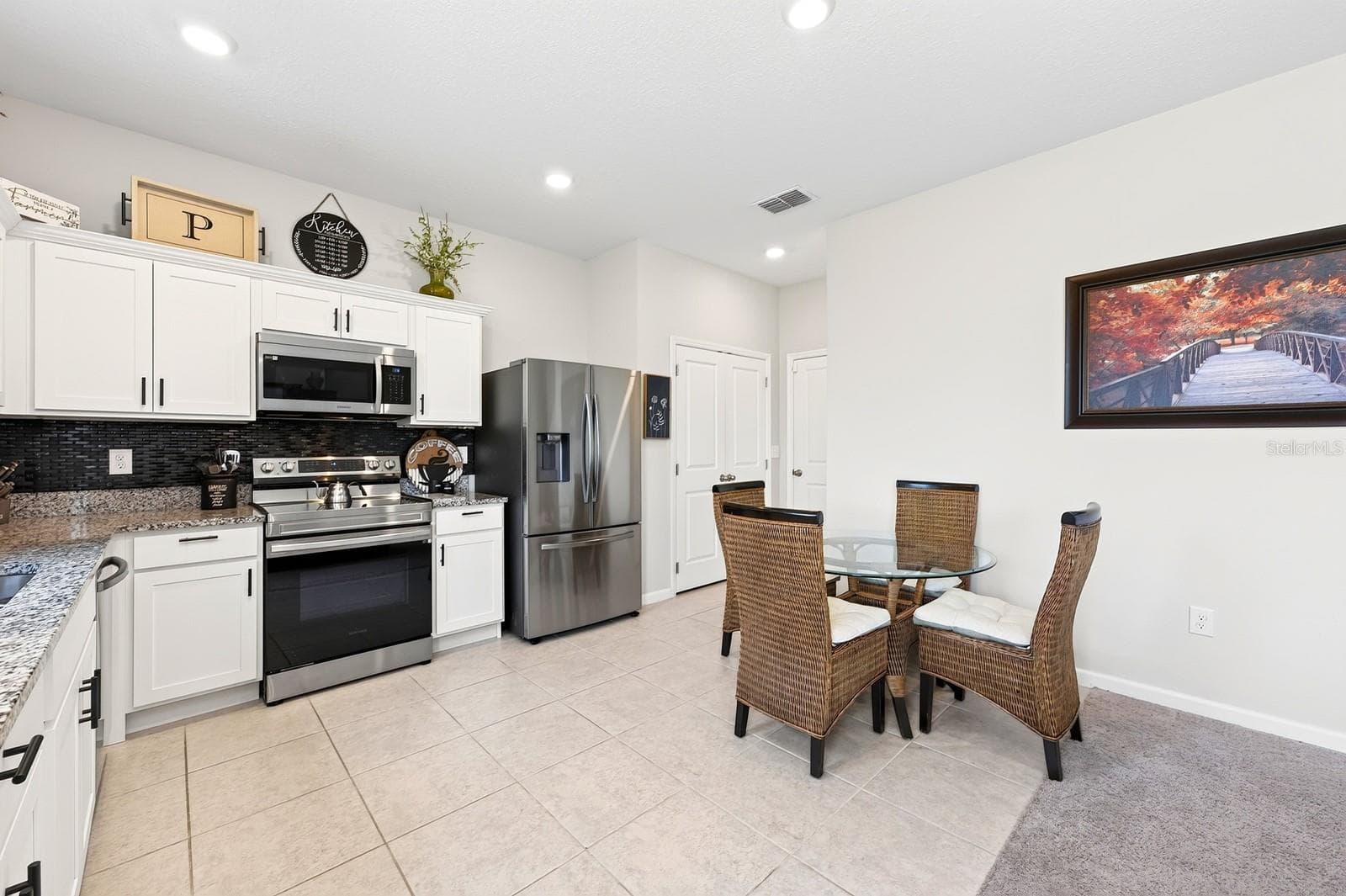 A SPACIOUS EAT-IN DINING AREA is perfect for casual family meals or gathering with friends. - 1961 HEMINGWAY CIR, GROVELAND