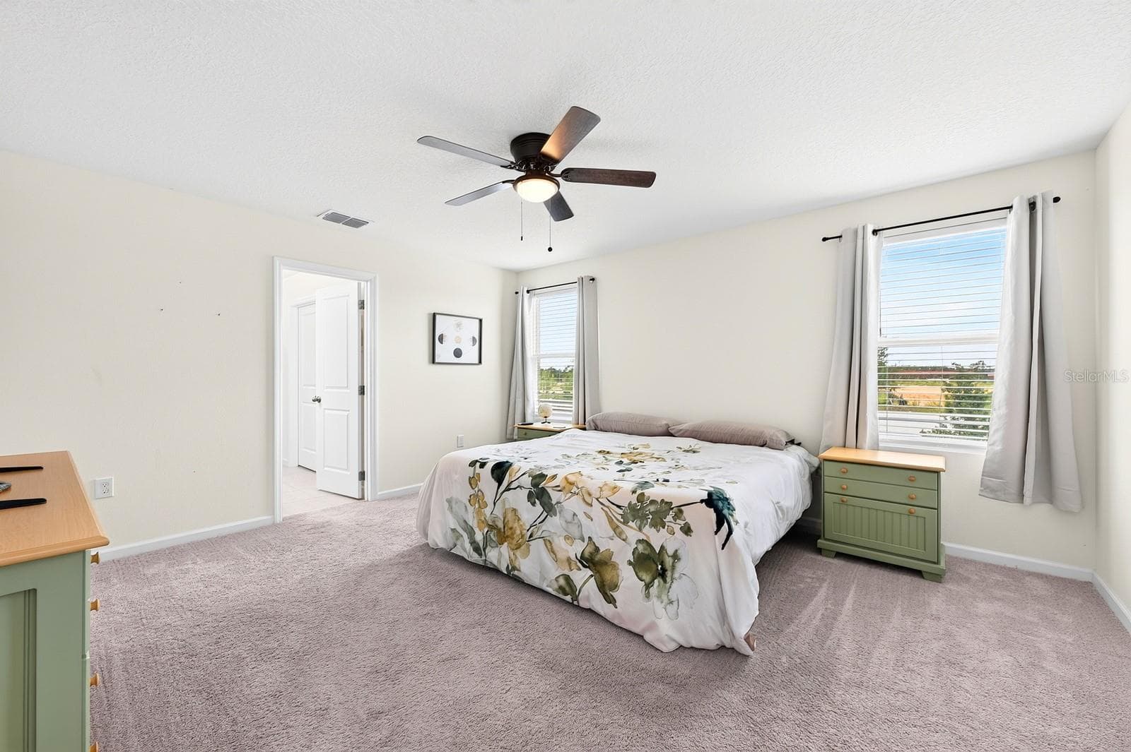The spacious Primary Suite features a huge walk-in closet and a PRIVATE EN SUITE BATH, designed for comfort and convenience. - 1961 HEMINGWAY CIR, GROVELAND