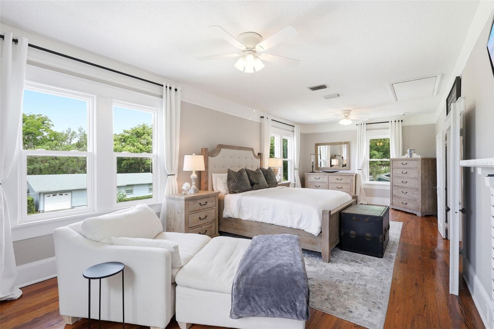 Upstairs primary bedroom with fireplace and brand-new Pella windows in 2025. - 47 DAVIS AVE, UMATILLA