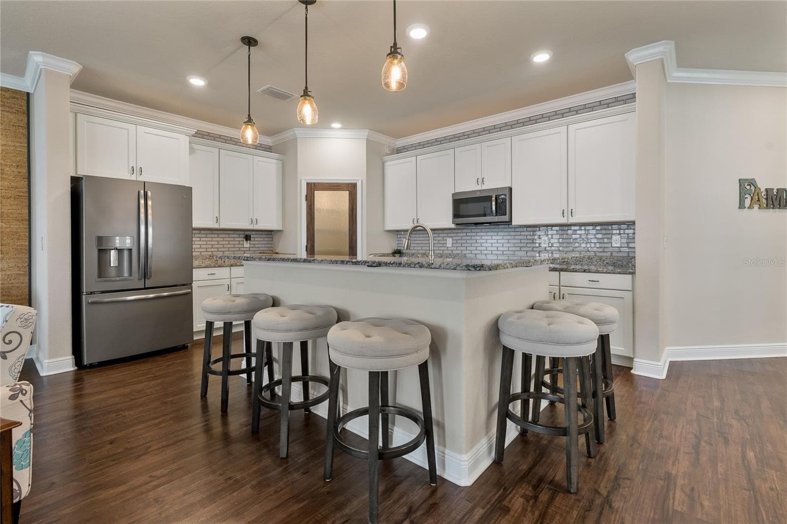Beautifully Appointed Kitchen with Stunning Tile Backsplash & Extended Island - 597 OZONA VILLAGE DR, PALM HARBOR