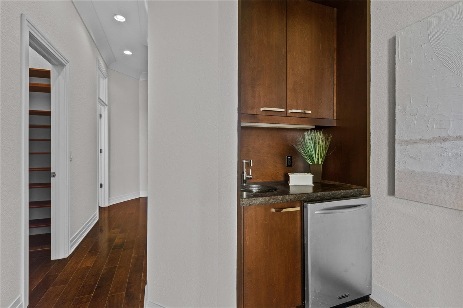 Wet bar in master bedroom suite includes a beverage refrigerator. - 1008 PASEO DEL RIO NE, ST PETERSBURG