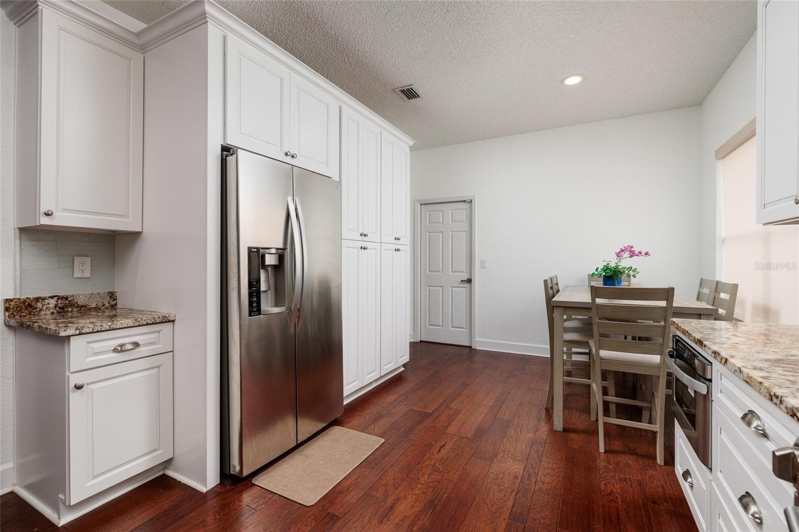 This kitchen has an abundance of cabinets.  The kitchen leads to the garage. - 1338 DARTFORD DR, TARPON SPRINGS