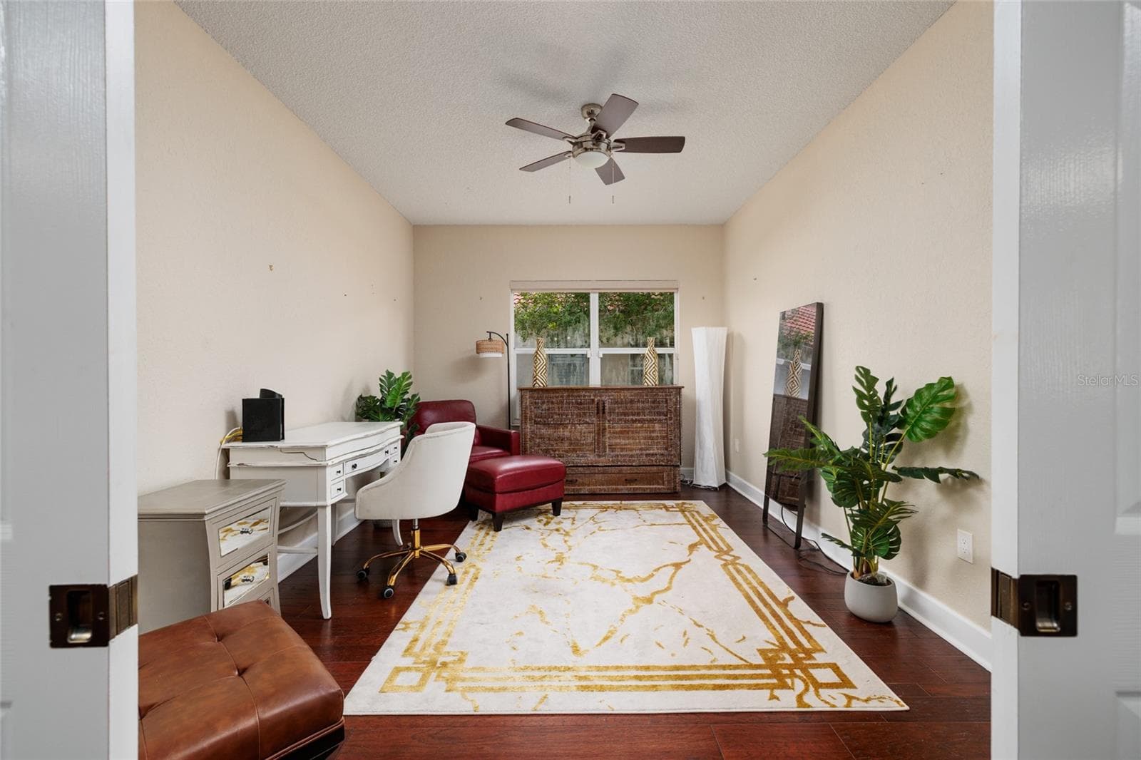 Currently this is bedroom is used as a den.  There is a closet to the right. - 1338 DARTFORD DR, TARPON SPRINGS