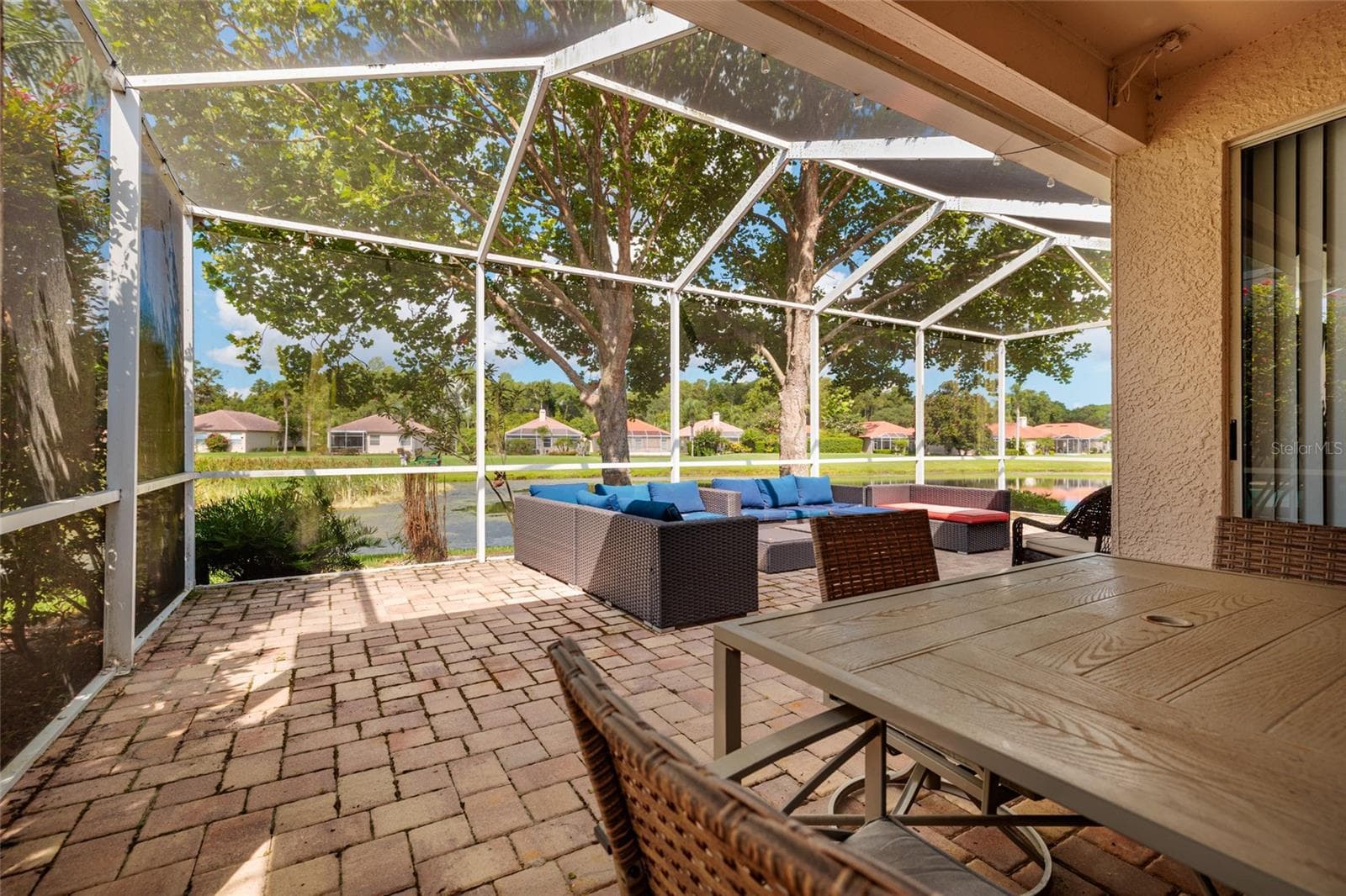 This large lanai overlooks the pond, perfect for entertaining and enjoying your time outside. - 1338 DARTFORD DR, TARPON SPRINGS