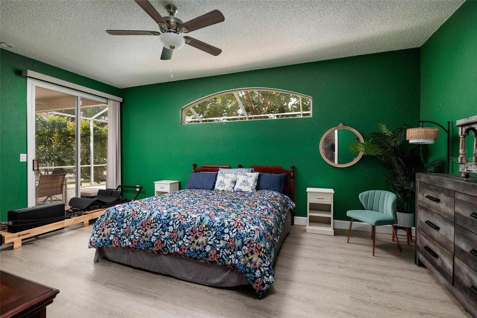Primary bedroom with sliders to the lanai. - 1338 DARTFORD DR, TARPON SPRINGS