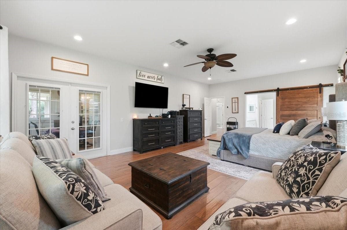 primary BR w/ornate barn door to bathroom - 3158 BEAUCHAMP CT, WINTER HAVEN