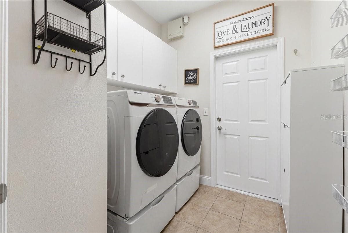 Inside laundry rm w/ overhead cabinets - 3158 BEAUCHAMP CT, WINTER HAVEN