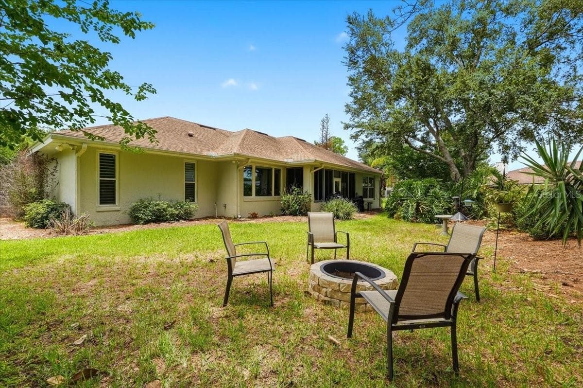 view of back of home by fire pit - 3158 BEAUCHAMP CT, WINTER HAVEN