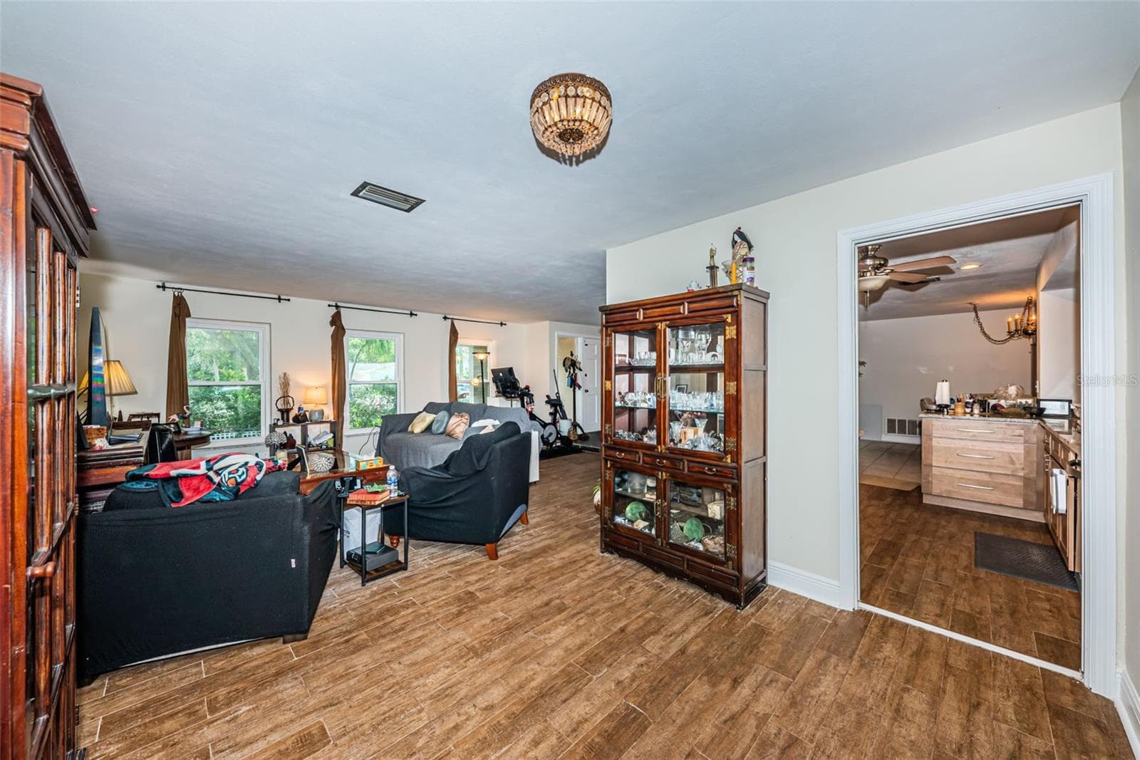 L-shaped living room with what was the dining space - 5230 VENETIAN BLVD NE, ST PETERSBURG