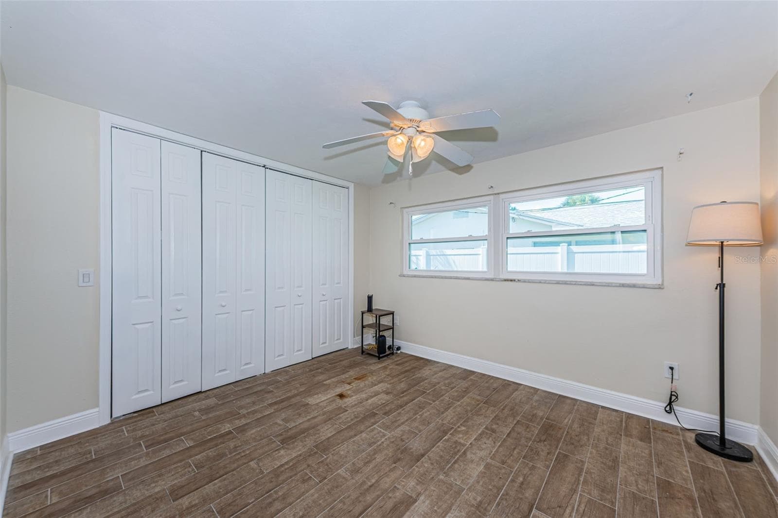 Bedroom 2 has pretty wood-look porcelain tile - 5230 VENETIAN BLVD NE, ST PETERSBURG