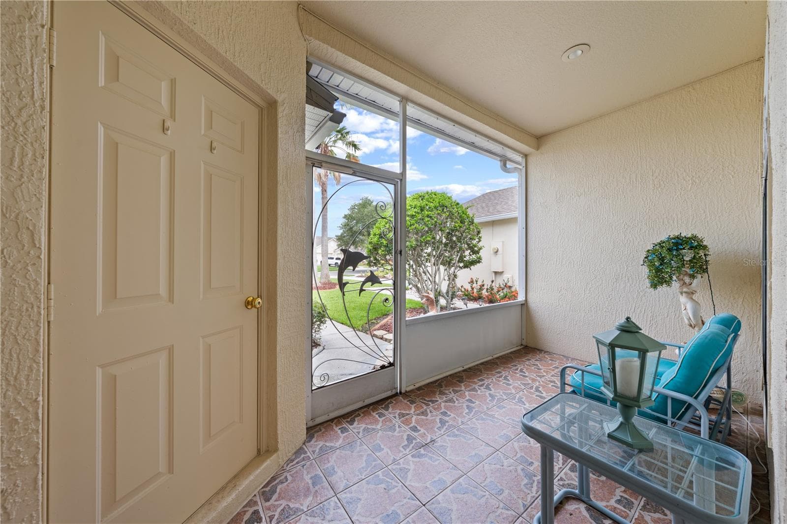 Front porch screened lanai with the door to left leading into the 1 car garage. - 153 CLUB VILLAS LN, KISSIMMEE