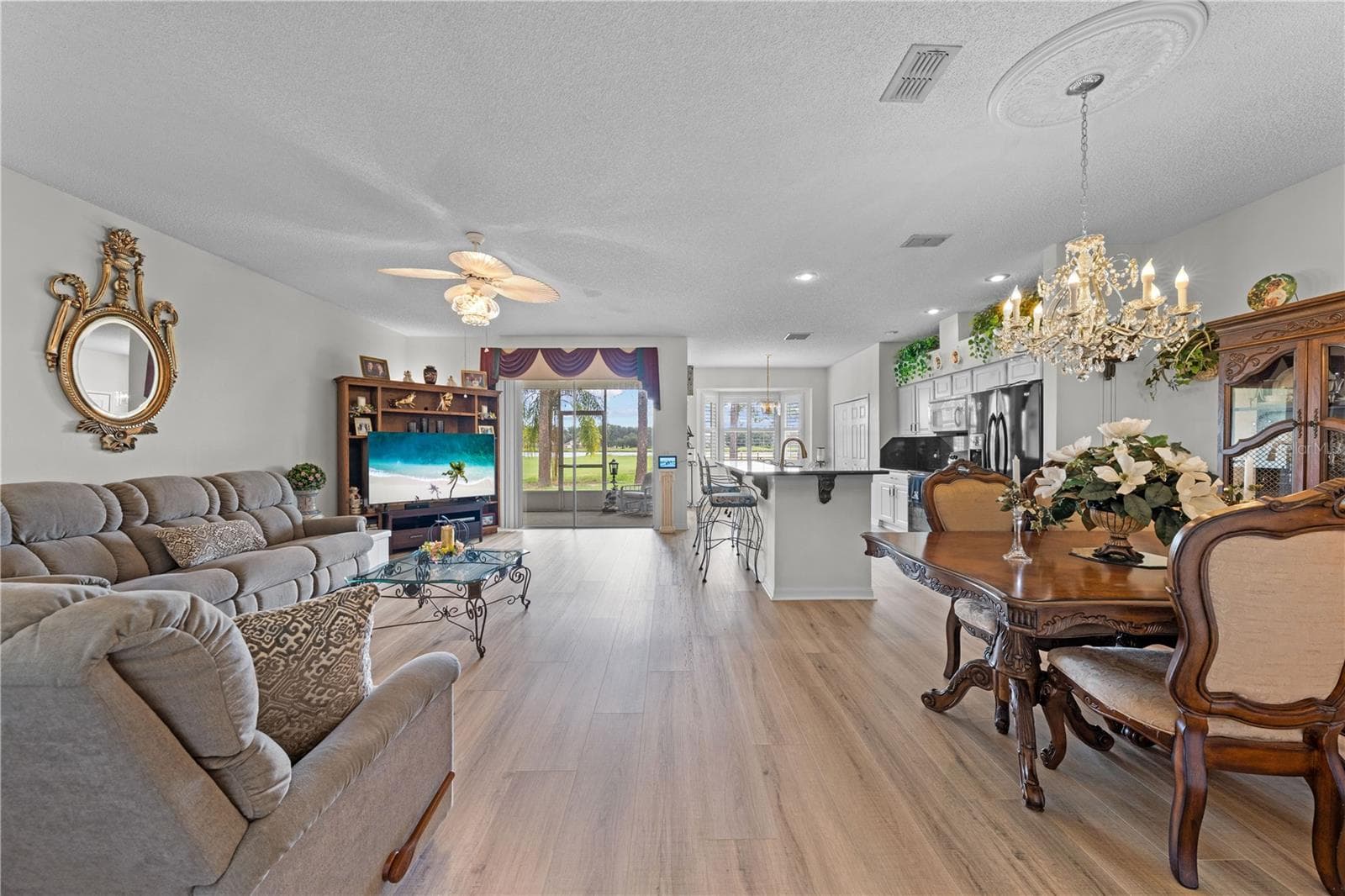 Combo living/dining room area with luxury vinyl. - 153 CLUB VILLAS LN, KISSIMMEE