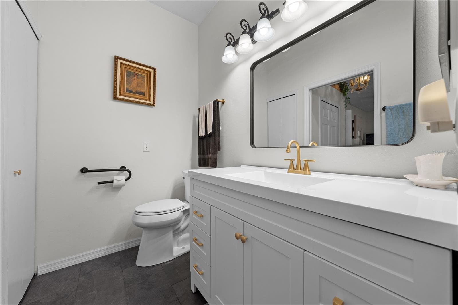 Primary bathroom with updated cabinets and vanity. - 153 CLUB VILLAS LN, KISSIMMEE