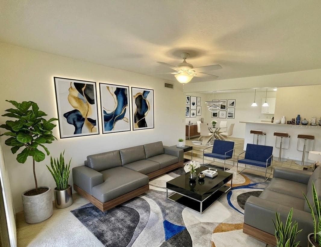Virtually staged living room with views to lake. - 145 N PEARL LAKE CSWY #112, ALTAMONTE SPRINGS