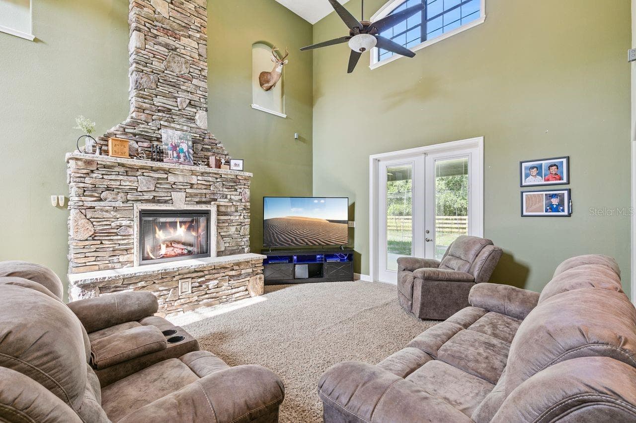 Living Room with French Doors that lead out to the Covered Patio - 36137 MATTAWAN DR, EUSTIS