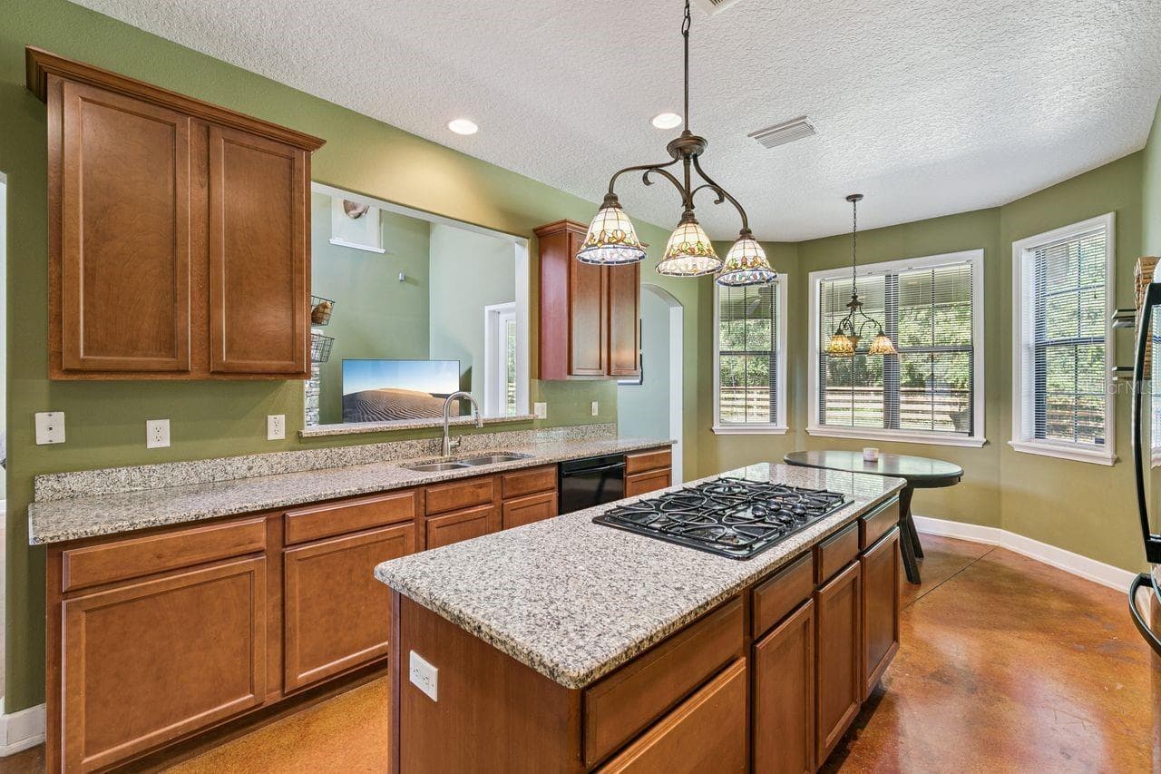 Kitchen with Granite Countertops, Cooking Island, Pantry, New Refrigerator - 36137 MATTAWAN DR, EUSTIS