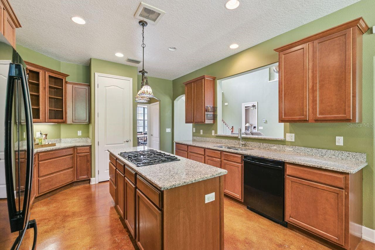 Kitchen with Granite Countertops, Cooking Island, Pantry, New Refrigerator - 36137 MATTAWAN DR, EUSTIS