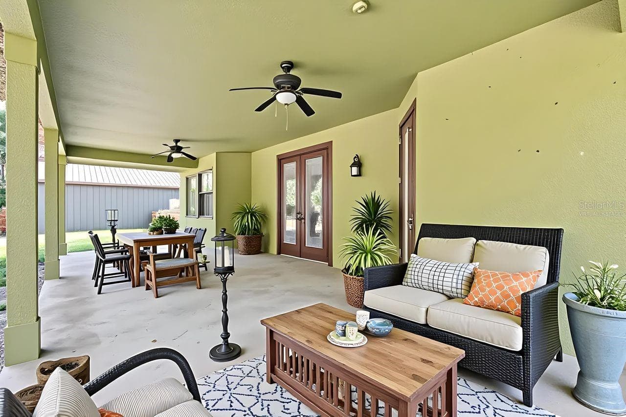Virtually Staged Large Covered Patio with view to the Conservation Area - 36137 MATTAWAN DR, EUSTIS