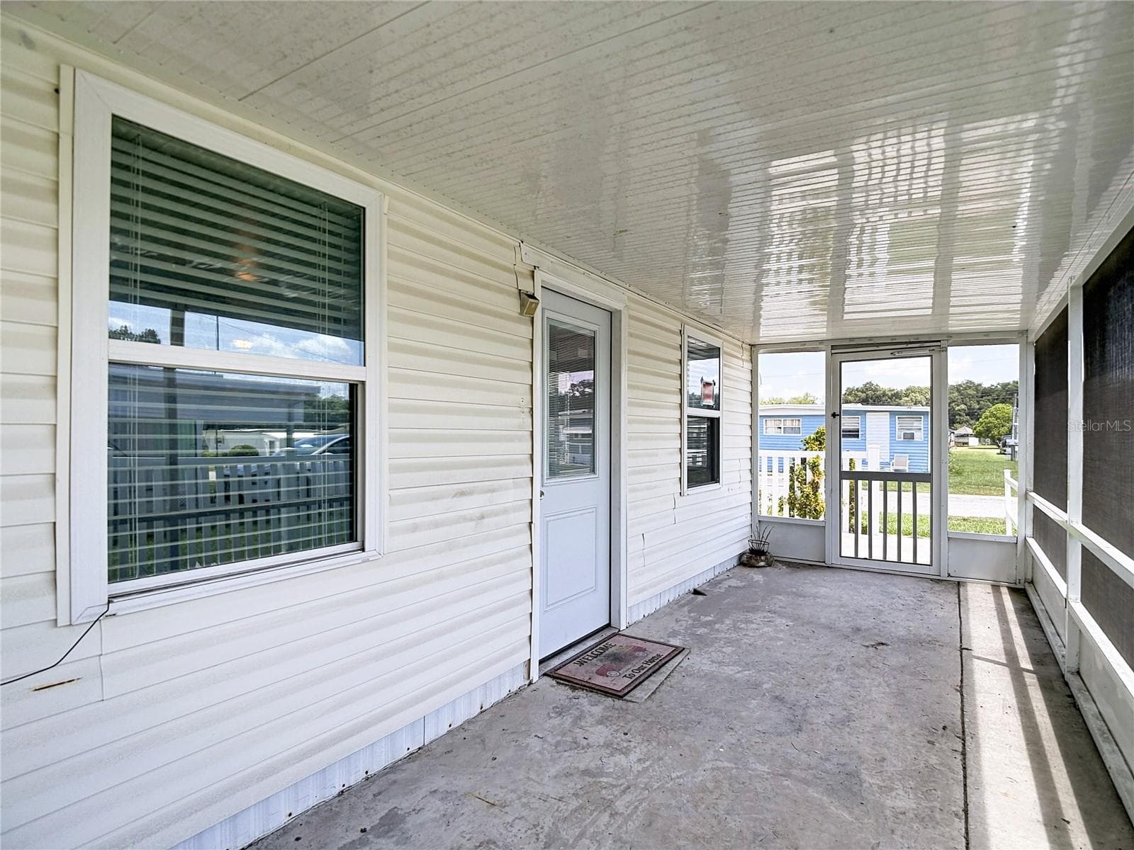 Front screened porch. One side has a lockable doggie door - 39032 OLA AVE, ZEPHYRHILLS