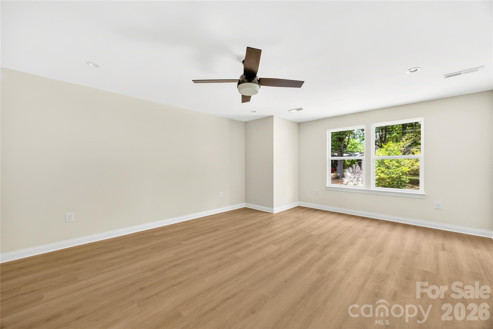 Large upstairs primary bedroom with ceiling fan in a new construction Charlotte home near NoDa - 1940 Purser Drive, Charlotte