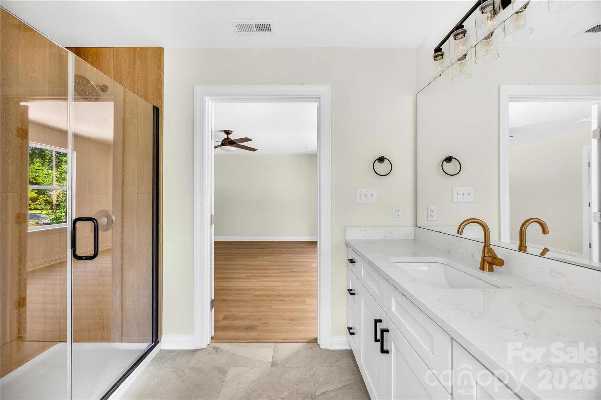 Primary bathroom vanity with plenty of counter space in a new construction Charlotte duet - 1940 Purser Drive, Charlotte