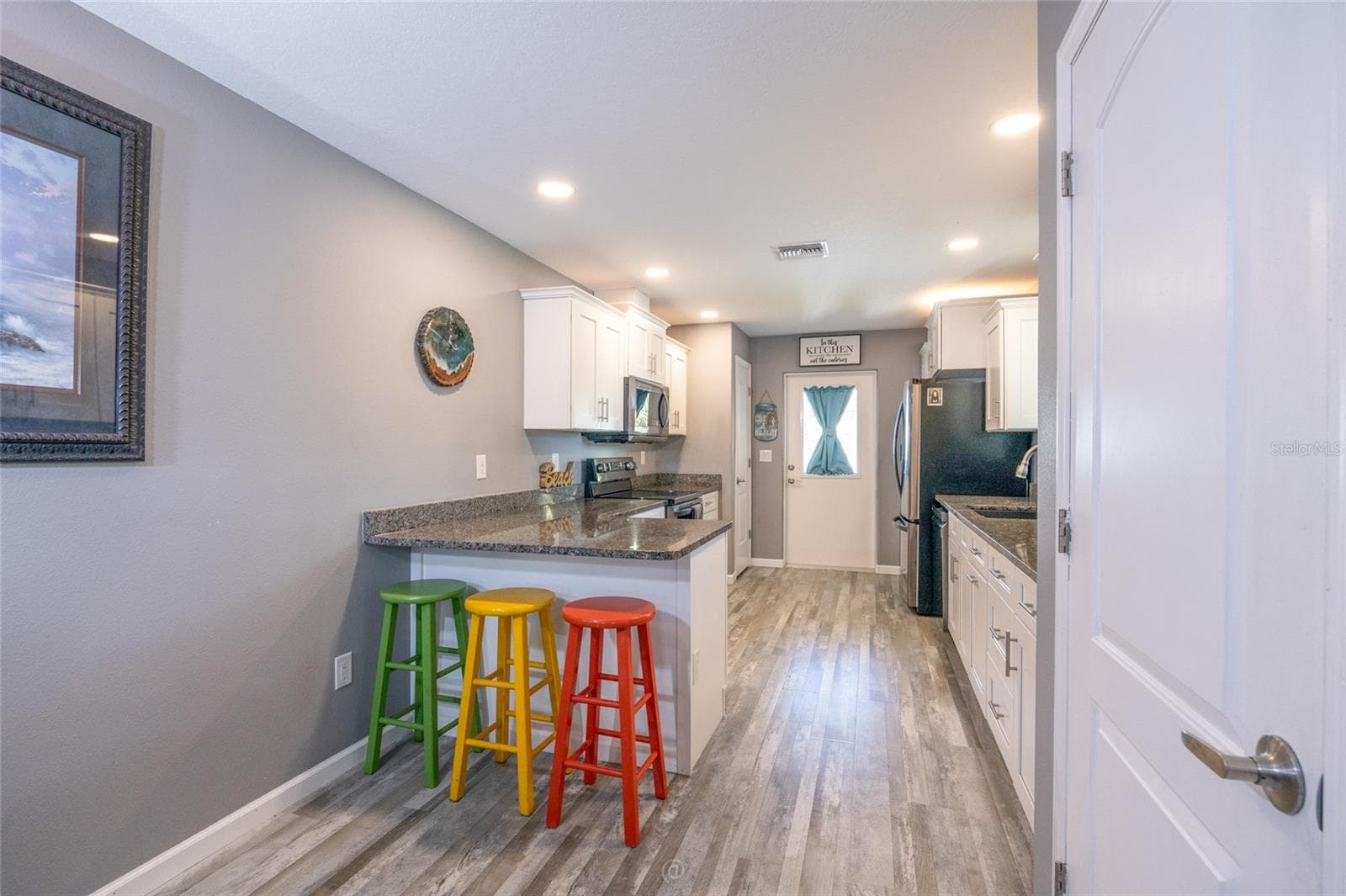 Bright kitchen leading to rear deck, backyard oasis & apartment or in-law suite - 904 S DAYTONA AVE, FLAGLER BEACH