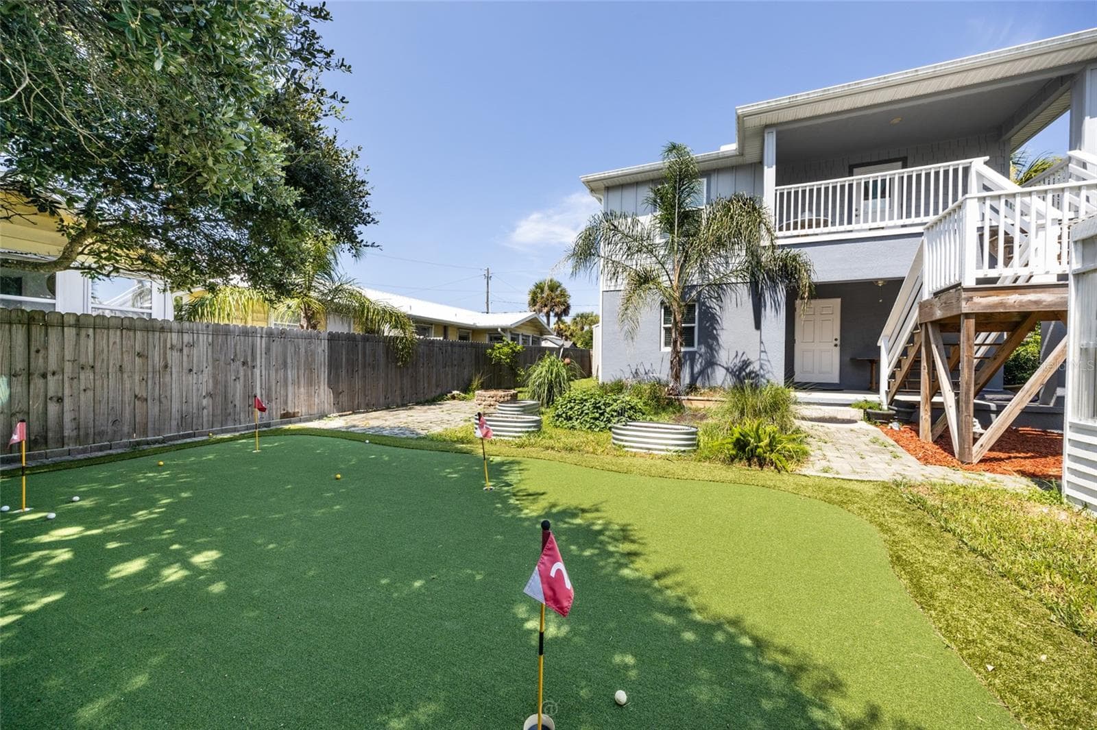 View of backyard, covered porch area on main floor - 904 S DAYTONA AVE, FLAGLER BEACH