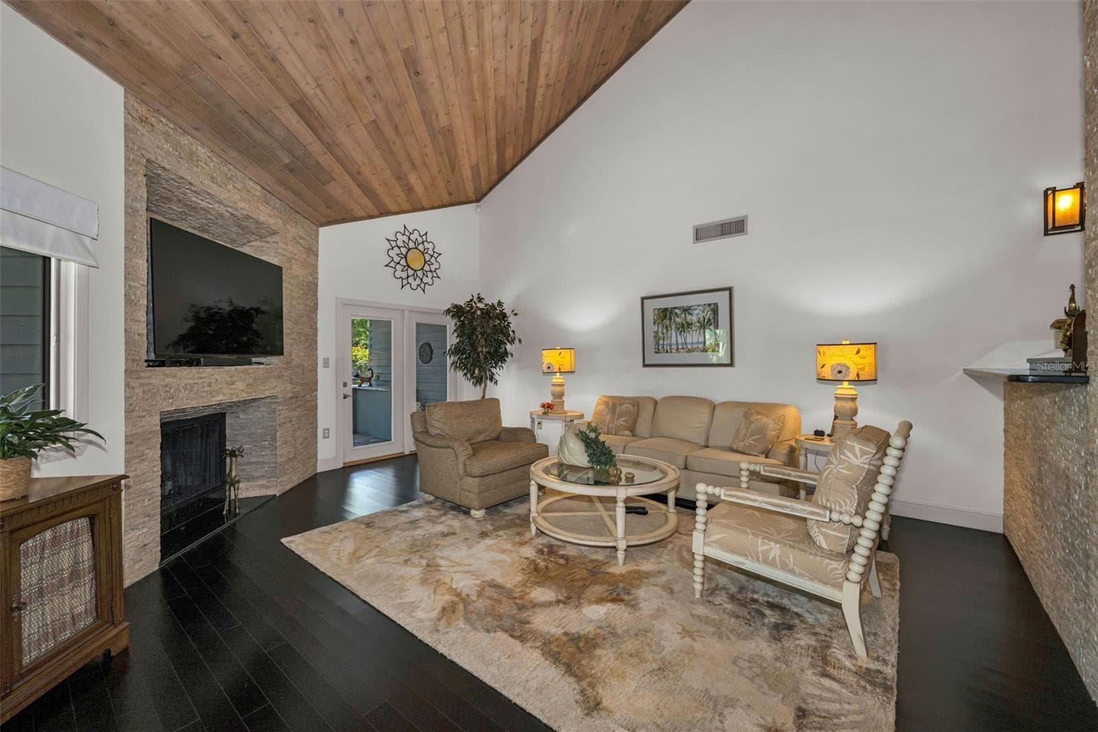 Living room with French doors, vaulted ceilings of tongue and groove wood, all leading to the pond side patio and grill area! So perfect for entertaining! - 10497 LONGWOOD DR, SEMINOLE