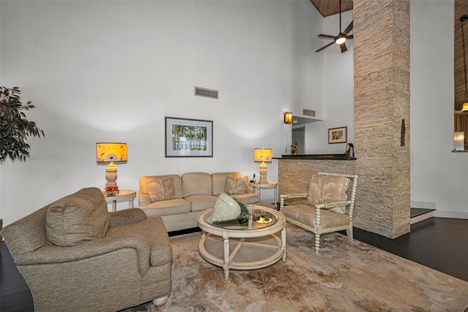 Living room with beautiful stacked stone details... - 10497 LONGWOOD DR, SEMINOLE
