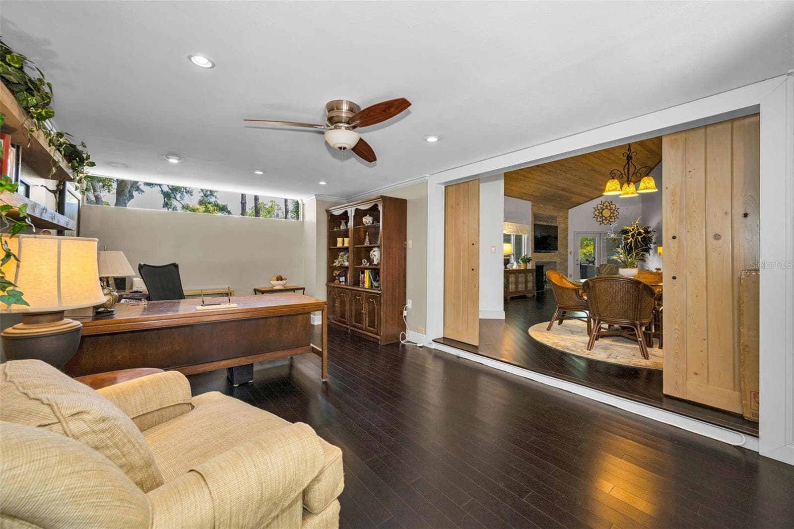 The spacious den, opens to the formal dining area and is next to the 2 car garage, see floor plan. Not all Arbors home have a den. This one has beautiful floors and great windows! - 10497 LONGWOOD DR, SEMINOLE