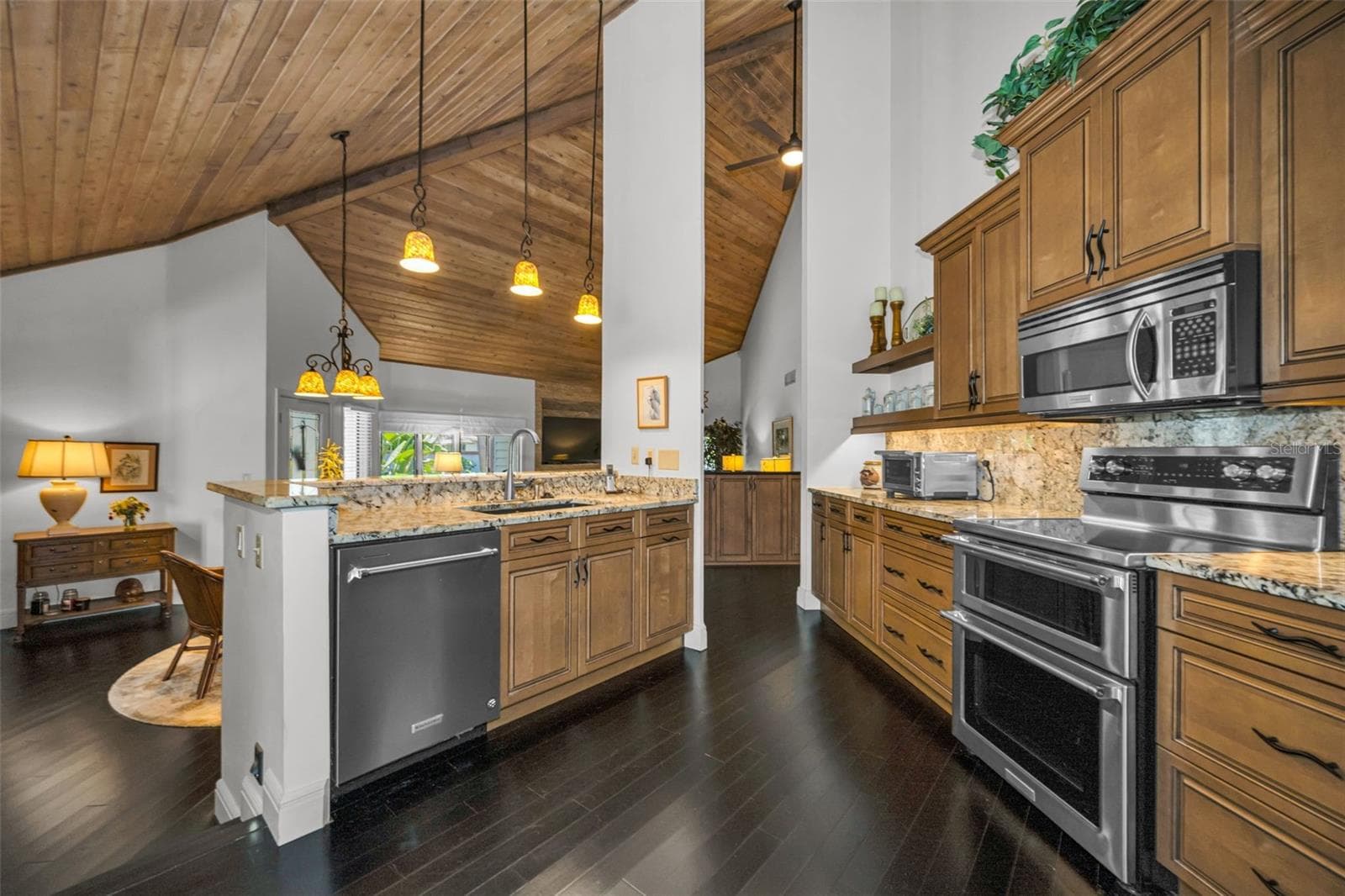 The kitchen overlooks the formal dining and the living room. You are part of the party! - 10497 LONGWOOD DR, SEMINOLE