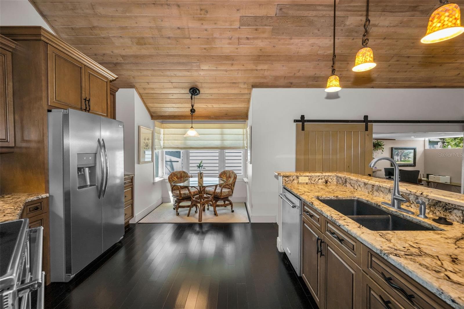 The kitchen has it's share of the tongue and groove ceiling giving it so much warmth and character. - 10497 LONGWOOD DR, SEMINOLE