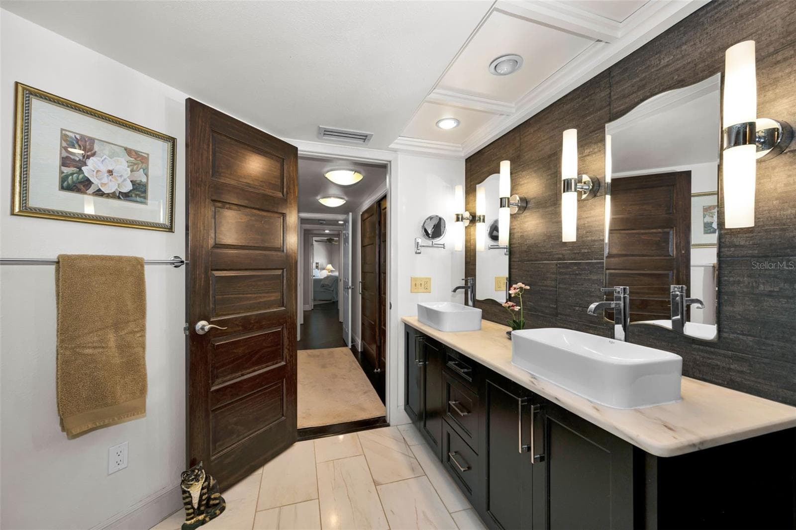 Master bath with distinct double sinks and lovely sconce lighting, custom mirrors and tile backsplash. - 10497 LONGWOOD DR, SEMINOLE