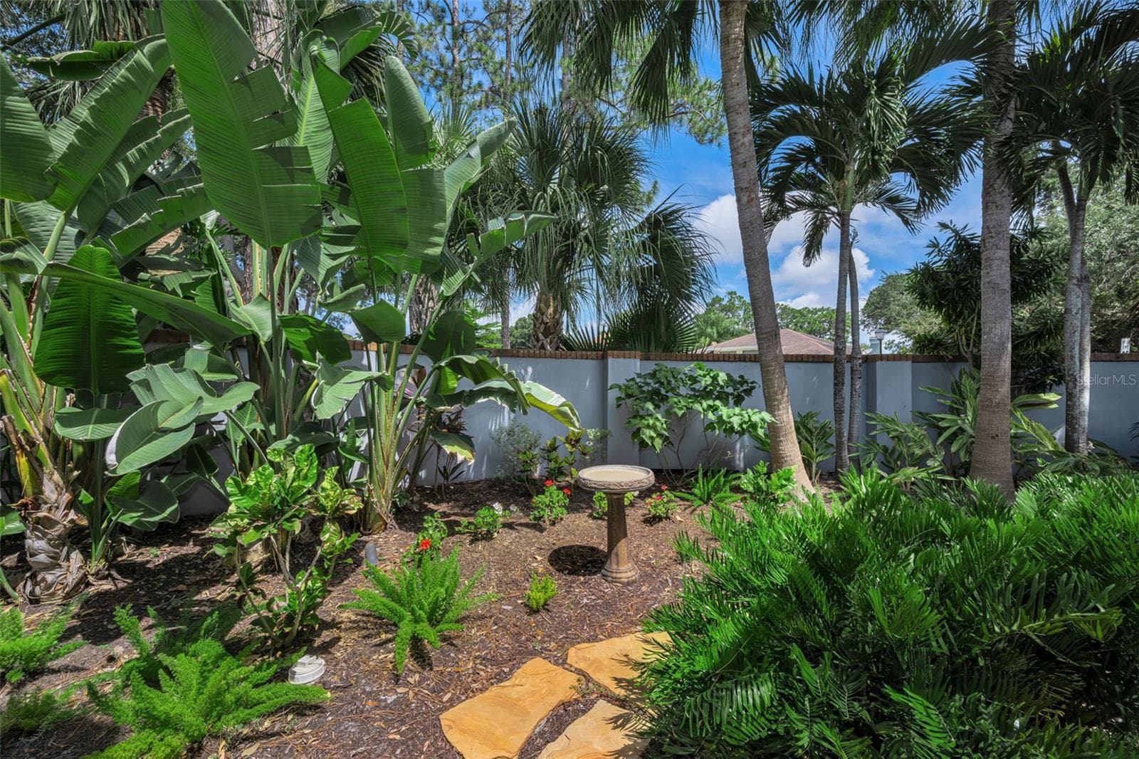 Lush garden area off the living room area and the front screened patio. - 10497 LONGWOOD DR, SEMINOLE