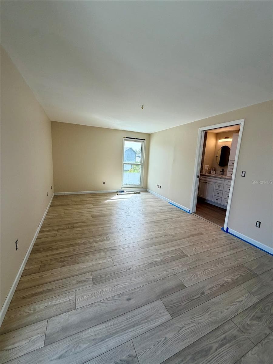Bright and open master bedroom with updated LVP and fresh paint. - 15705 CASHMERE LN, TAMPA