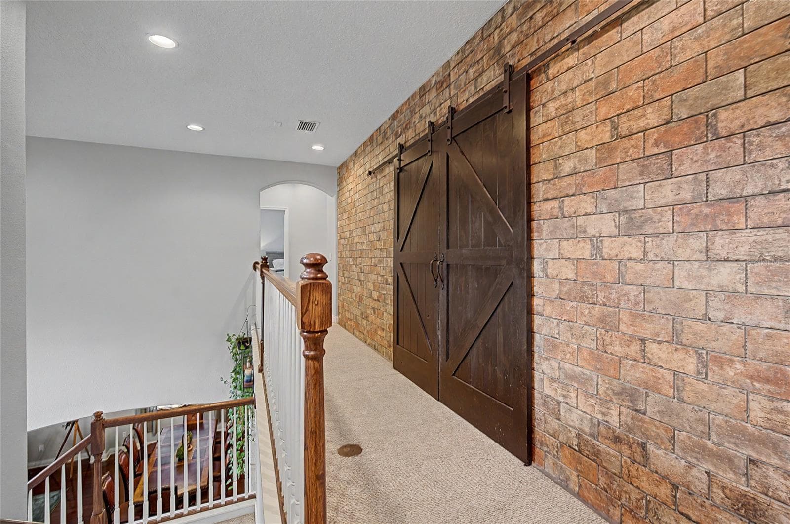 Brick accent wall upstairs to Bonus room - 3038 MARBLE CREST DR, LAND O LAKES