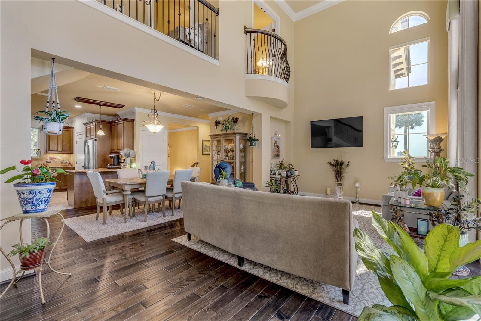 juliet balcony from the primary bedroom overlooks the living room - 5090 RIVERSIDE DR #105, PORT ORANGE